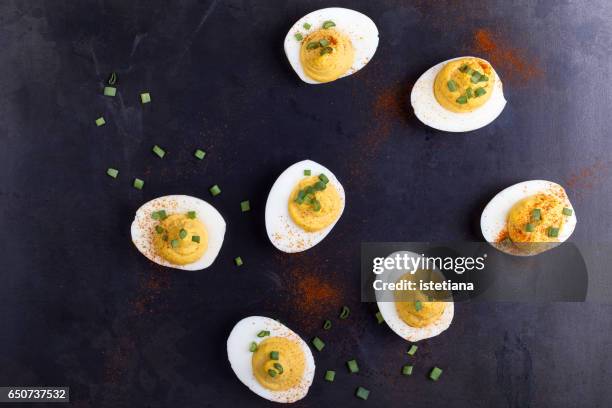 deviled eggs topped with green onion and paprika - hard boiled eggs fotografías e imágenes de stock