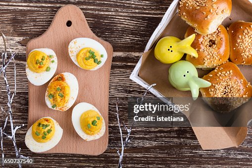 Deviled eggs and homemade buns on Easter table Deviled eggs and homemade buns on Easter table