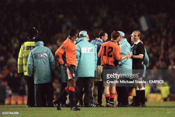 Referee Mike Riley is given an escort from the field by stewards and police after many of his decisions angered both sets of players and...