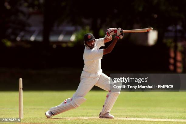 Bangladesh's Athar Ali Khan cuts the ball away