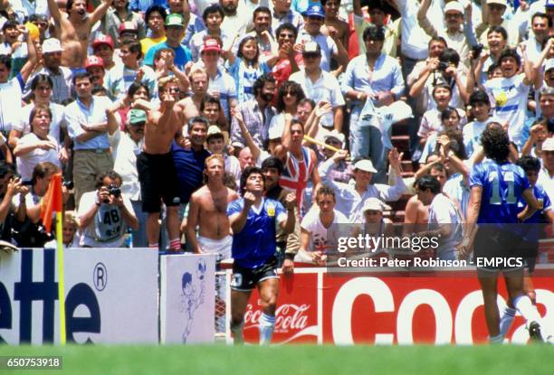 England fans look on as Diego Maradona of Argentina celebrates his second goal