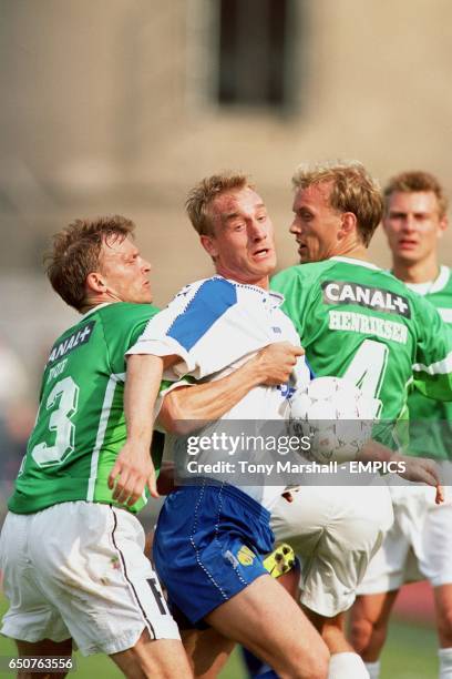 S Jonny Laursen battles with AB's Jan Bjur and Rene Henriksen for the ball