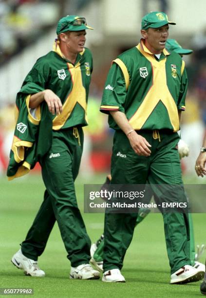 South Africa's Allan Donald and Shaun Pollock head back to the pavillion after capturing nine of the Australian wickets between them