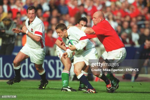 England's Jonny Wilkinson is grabbed by Wales's Craig Quinnell