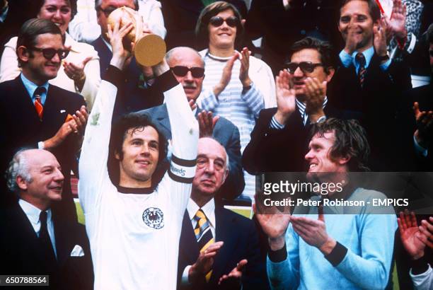West Germany captain Franz Beckenbauer lifts the World Cup as goalkeeper Sepp Maier applauds