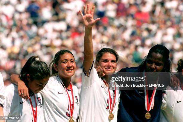 S Lorrie Fair, Tiffany Roberts, Mia Hamm and Briana Scurry celebrate winning the World Cup