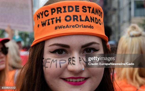Woman wears a bandana indicating that New York City's gay community stands with those killed in the 2016 Orlando, Florida night club shooting, during...