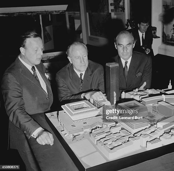 Desmond Plummer , Leader of the Greater London Council, with architects Dennis Lennon and Herbert Fitzroy Robinson , inspecting a model of the...