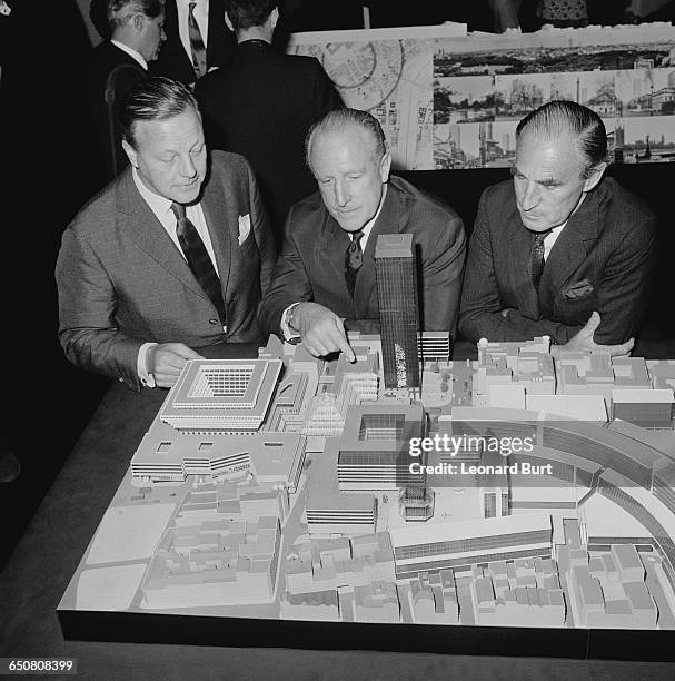 Desmond Plummer , Leader of the Greater London Council, with architects Dennis Lennon and Herbert Fitzroy Robinson , inspecting a model of the...