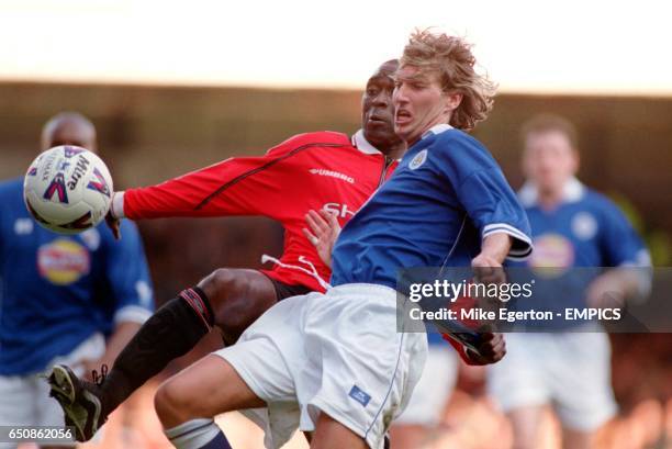 Manchester United's Andy Cole battles for possession of the ball with Leicester City's Robbie Savage