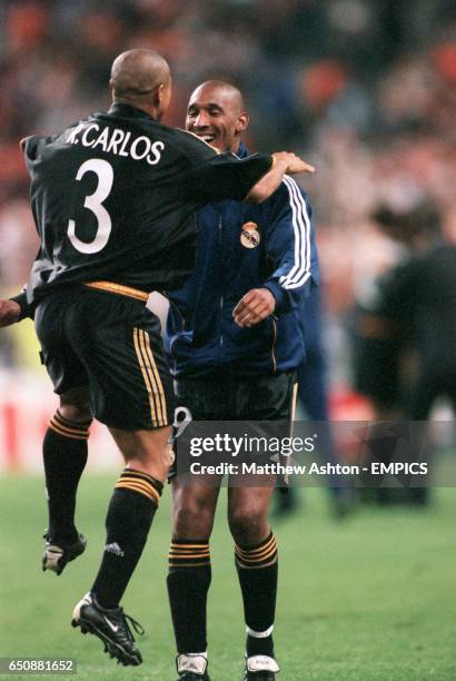 Real Madrid's Roberto Carlos runs to celebrate with teammate Nicolas Anelka