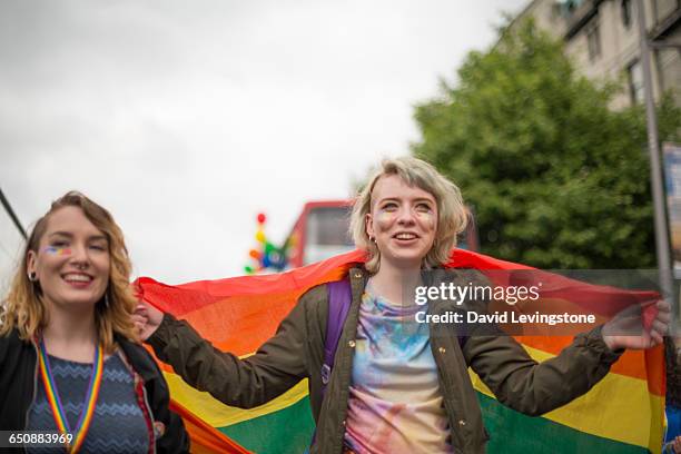 lesbian couple celebrating pride - gay pride parade stock pictures, royalty-free photos & images