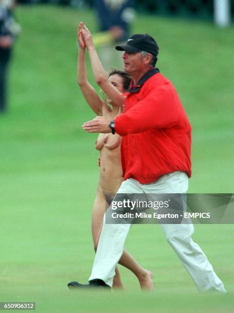 Jacqui Salmond, a streaker is escorted away by Tiger Woods' personal security guard