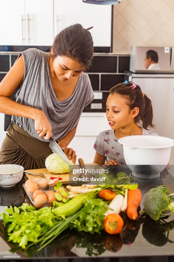 Asian Mother and Daughter Cooking Healthy Food Together