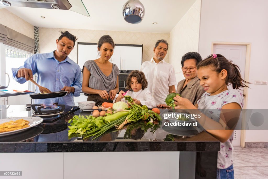 Three Generation Asian Family Cooking Healthy Food Together