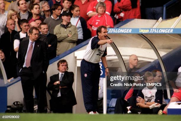 Liverpool manager Gerard Houllier looks on as his assistant Phil Thompson barks out the orders