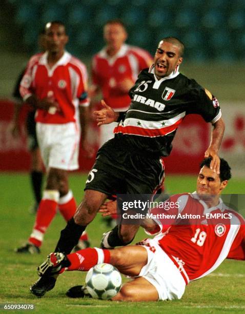 Abdul Wahab of Iraq is tackled by Lebanon's Mouhamad Al Reda