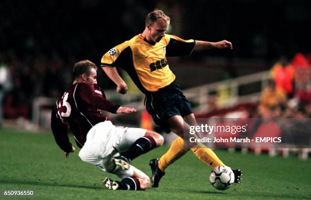 Sparta Prague's Rene Bolf tackles Arsenal's Dennis Bergkamp