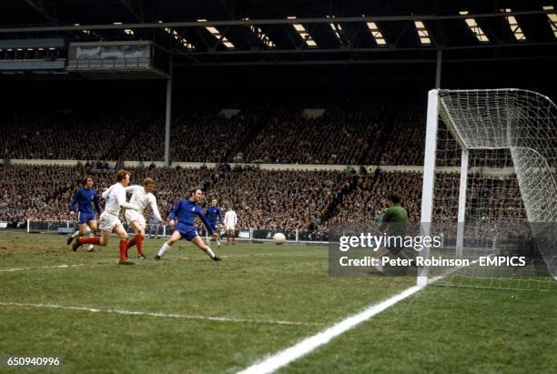 Leeds United's Mick Jones fires a shot at Chelsea goalkeeper Peter Bonetti , watched by teammate Billy Bremner , and Chelsea's Dave Webb and John...