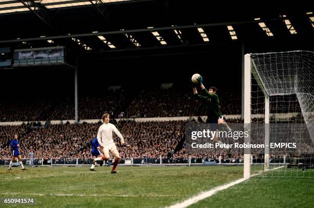 Chelsea goalkeeper Peter Bonetti leaps to catch a cross as Leeds United's Allan Clarke looks on