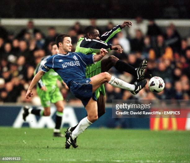 Chelsea's Dennis Wise and Peterborough United's Andy Clarke battle for the ball