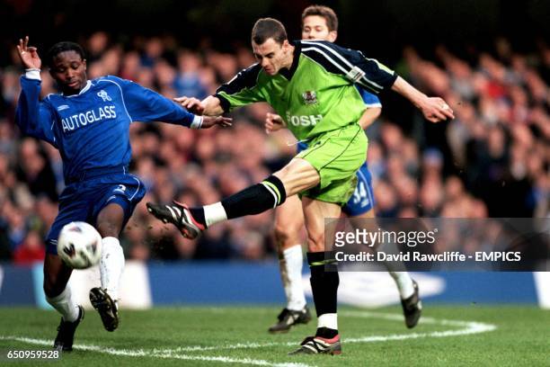 Peterborough United's David Farrell shoots at goal as Chelsea's Celestine Babayaro comes across to block