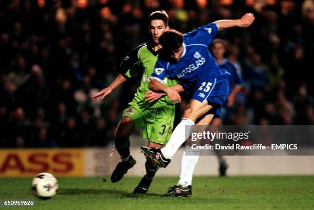 Chelsea's Gianfranco Zola fires home his second goal of the match as Peterborough United's Adam Drury looks on