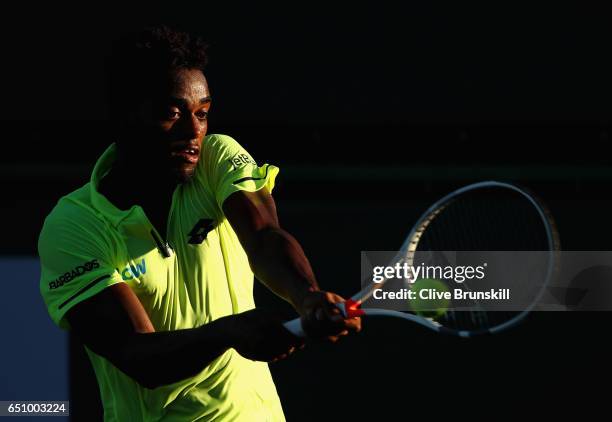 Darian King of Barbados plays a backhand against Nikoloz Basilashvili of Georgia in their first round match during day four of the BNP Paribas Open...