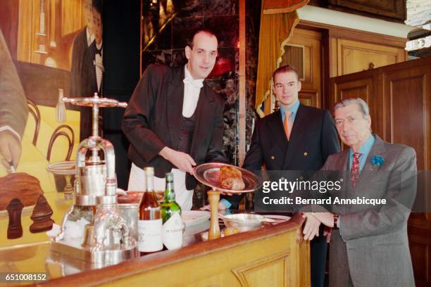 Claude Terrail , owner of the famous La Tour d'Argent restaurant in Paris, and his son Andre , attend the serving of the restaurant's millionth duck....