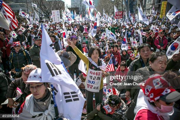 Supporters of President Park Geun-hye react emotionally as the Constitutional Court had ruled the impeachment near the court on March 10, 2017 in...