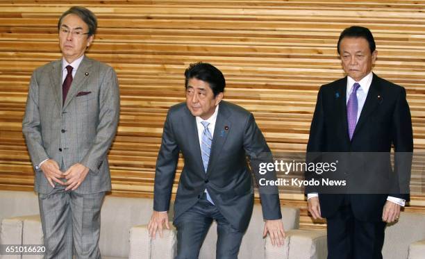 Japanese Prime Minister Shinzo Abe , Finance Minister Taro Aso and Nobuteru Ishihara, minister in charge of revitalizing the economy, attend a...