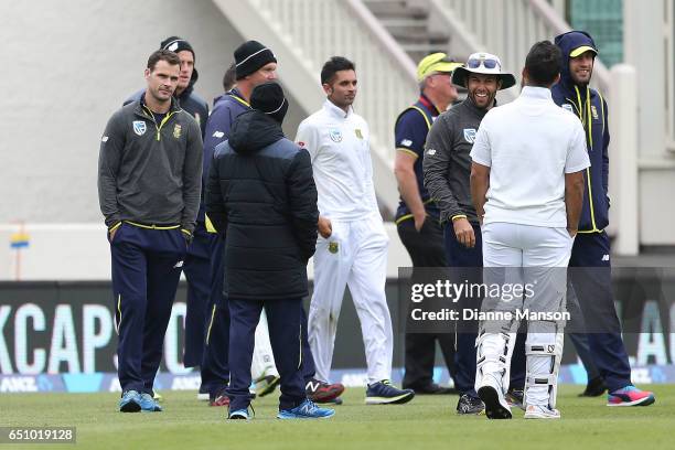 Players and team management leave due to a full field evacuation during day three of the First Test match between New Zealand and South Africa at...