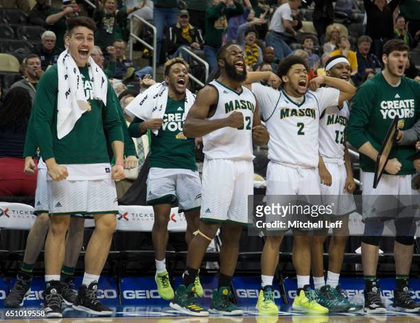 Ian Boyd, Kameron Murrell, Karmari Newman and the rest of the George Mason Patriots bench reacts against the Fordham Rams in the second round of the...