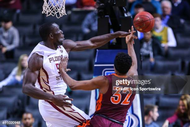 Florida State Seminoles center Michael Ojo blocks the shot of Virginia Tech Hokies forward Zach LeDay during the first half of the 2017 New York Life...