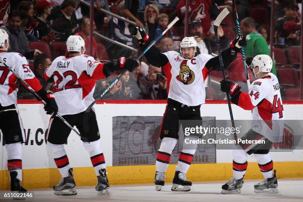 Erik Karlsson of the Ottawa Senators celebrates with Chris Kelly and Jean-Gabriel Pageau after Karlsson scored the game winning goal against the...