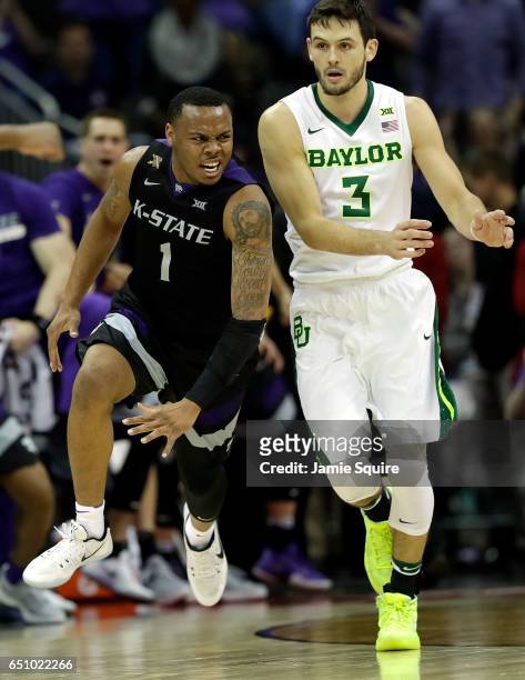 Carlbe Ervin II of the Kansas State Wildcats celebrates after making a three-pointer during the quarterfinal game of the Big 12 Basketball Tournament...