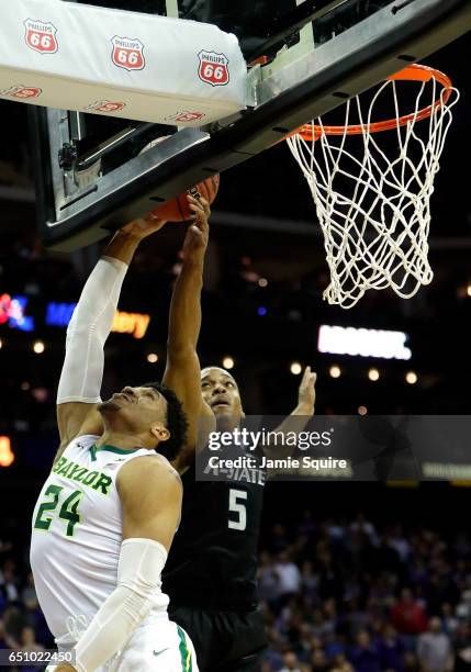 Barry Brown of the Kansas State Wildcats blocks a shot by Ishmail Wainright of the Baylor Bears during the quarterfinal game of the Big 12 Basketball...