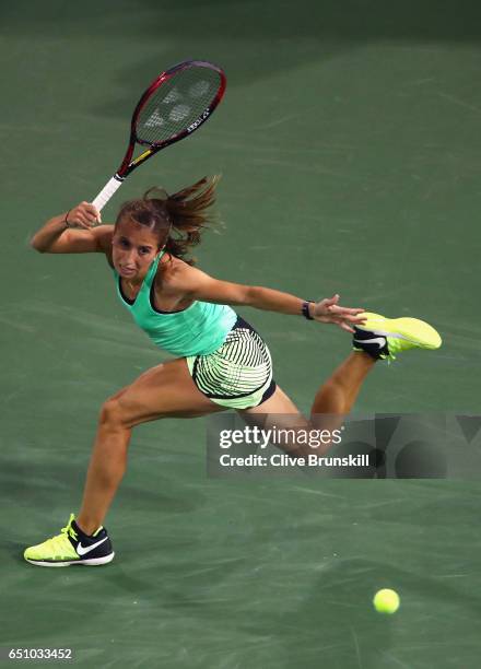 Annika Beck of Germany plays a forehand against Eugenie Bouchard of Canada in their first round match during day four of the BNP Paribas Open at...