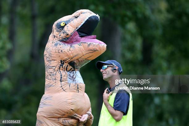 Supporter is asked to remove the dinosaur costume by security during day three of the First Test match between New Zealand and South Africa at...