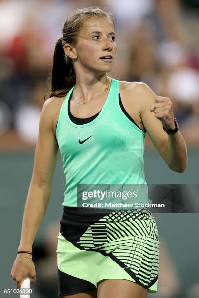 Annika Beck of Germany celebrates a point against Eugenie Bouchard of Canada during the BNP Paribas Open at the Indian Wells Tennis Garden on March...