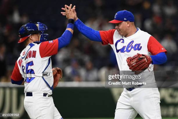 Pitcher Miguel Lahera and Catcher Frank Morejon of Cuba celebrate their 3-4 victory after the World Baseball Classic Pool B Game Five between...