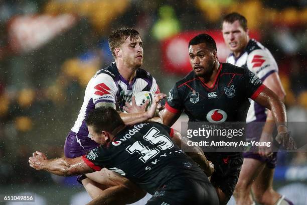 Cameron Munster of the Storm makes a run at Jacob Lillyman of the Warriors during the round two NRL match between the New Zealand Warriors and the...