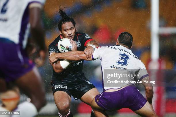 Solomone Kata of the Warriors makes a run at Will Chambers of the Storm during the round two NRL match between the New Zealand Warriors and the...