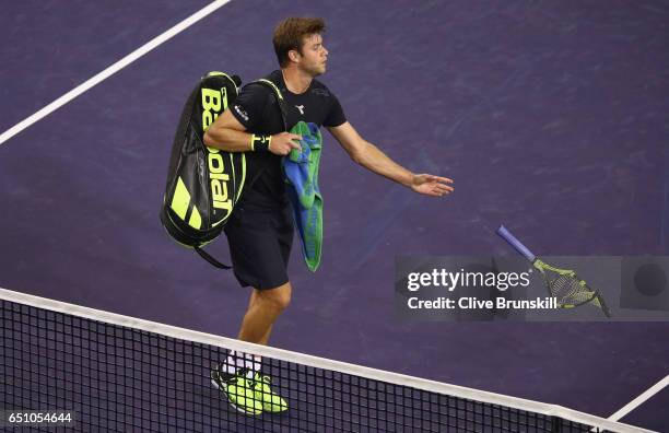 Ryan Harrison of the United States throws his broken racket back to his bench after a three set defeat by Damir Dzumhur of Bosnia and Herzegovina in...