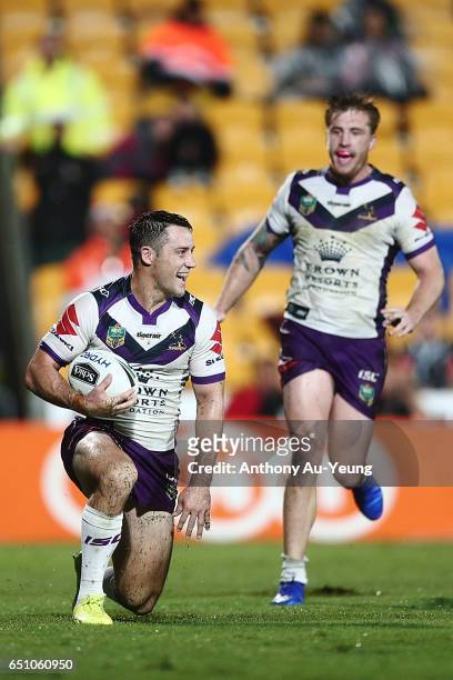 Cooper Cronk of the Storm celebrates after scoring a try during the round two NRL match between the New Zealand Warriors and the Melbourne Storm at...
