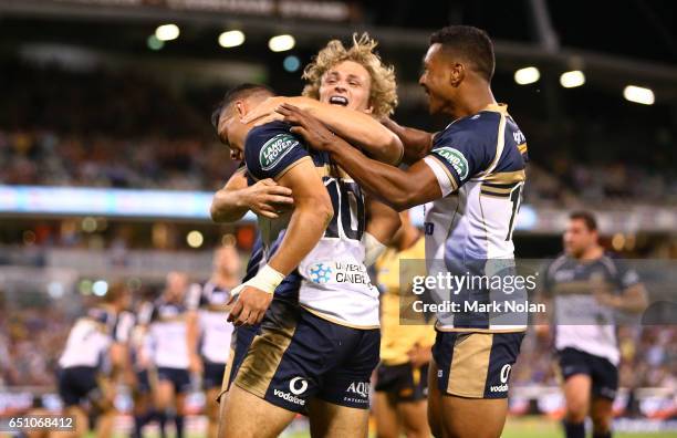 Wharenui Hawera of the Brumbies is congratulated by teeam mates after scoring a try during the round three Super Rugby match between the Brumbies and...