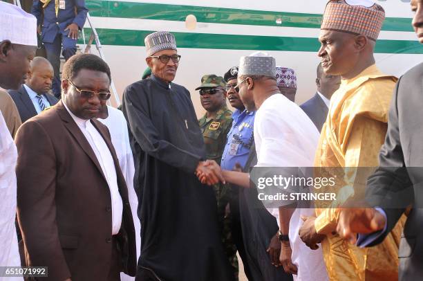 Nigerian President Muhammadu Buhari disembarks from an aircraft upon his arrival at the Nigerian Airforce base in Kaduna, on March 10, 2017. Buhari...