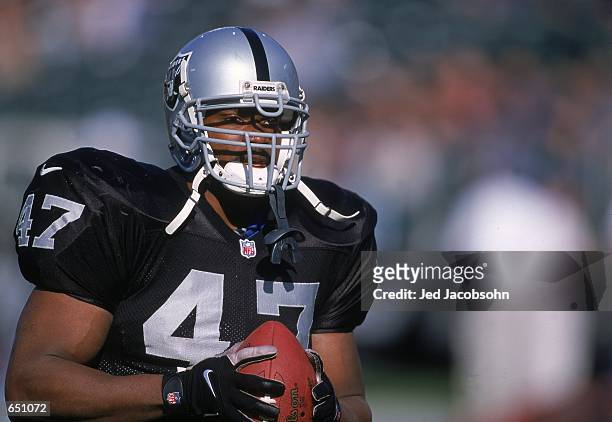 Tyrone Wheatley of the Oakland Raiders looks on holding the ball during the game against the Atlanta Falcons at the Network Associates Coliseum in...