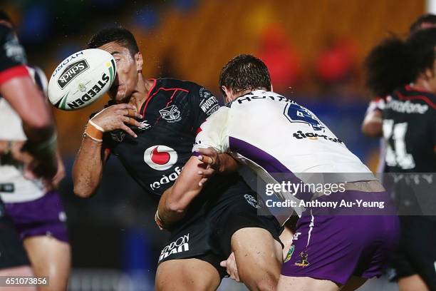 Mafoa'aeata Hingano of the Warriors loses the ball in the tackle from Cheyse Blair of the Storm during the round two NRL match between the New...