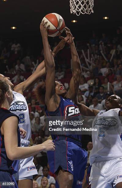 Wendy Palmer of the Detroit Shock goes up for a shot over Elaine Powell of the Orlando Miracle during the game at TD Waterhouse Centre in Orlando,...